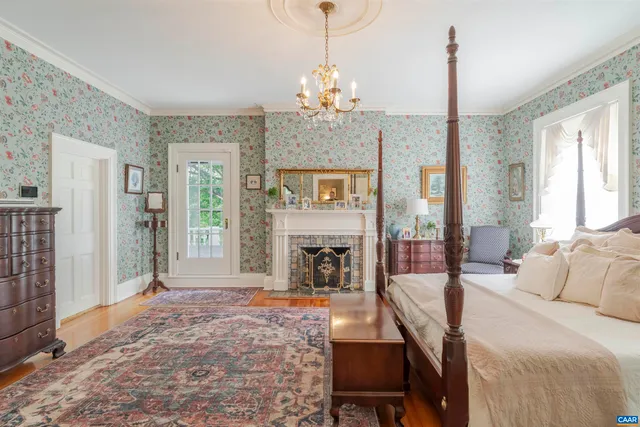 a living room with furniture a fireplace and a chandelier