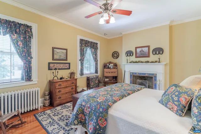 a bedroom with a bed and a fireplace