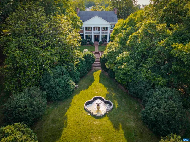 a aerial view of a house with swimming pool and garden view
