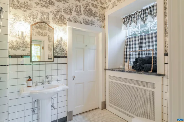 a bathroom with a sink a mirror and shower