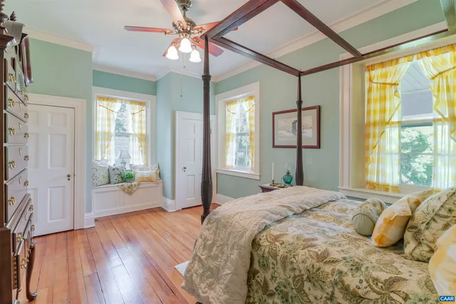 a bedroom with a large bed and a window