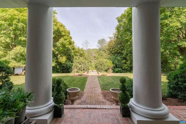 a view of a patio with table and chairs potted plants