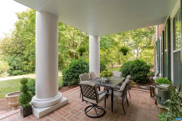 a dining room with furniture and garden view