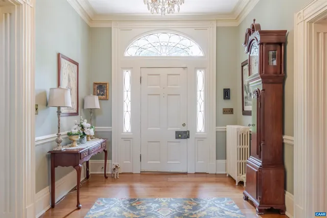 a view of a hallway with bathroom and glass door