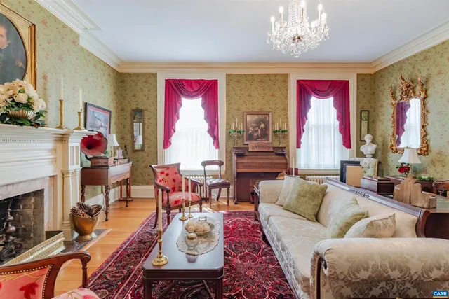a living room with furniture and a chandelier