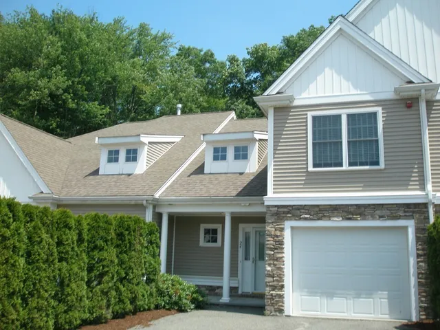 a view of a house with a yard and plants