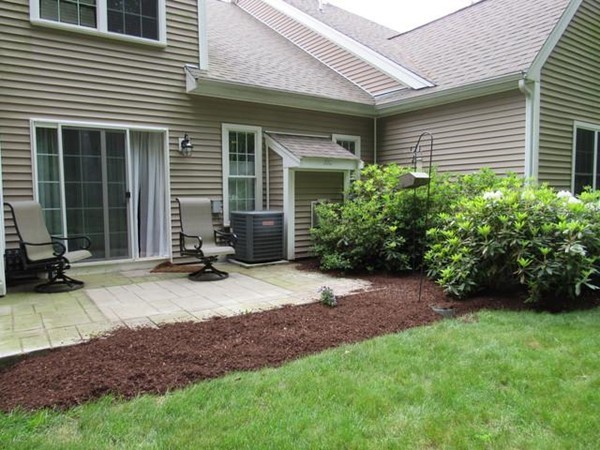 24 Leanne Way, Unit 24 Franklin, MA 02038 - Photo 2 of 18 a view of a backyard with plants and a patio