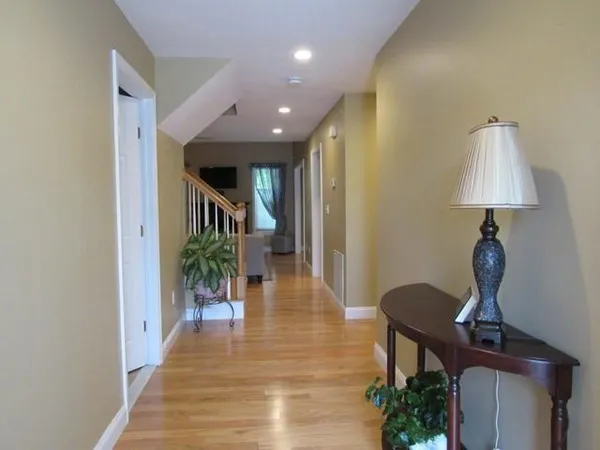 a hallway with a dining table and chairs
