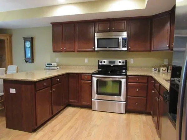 a kitchen with a sink a stove and microwave