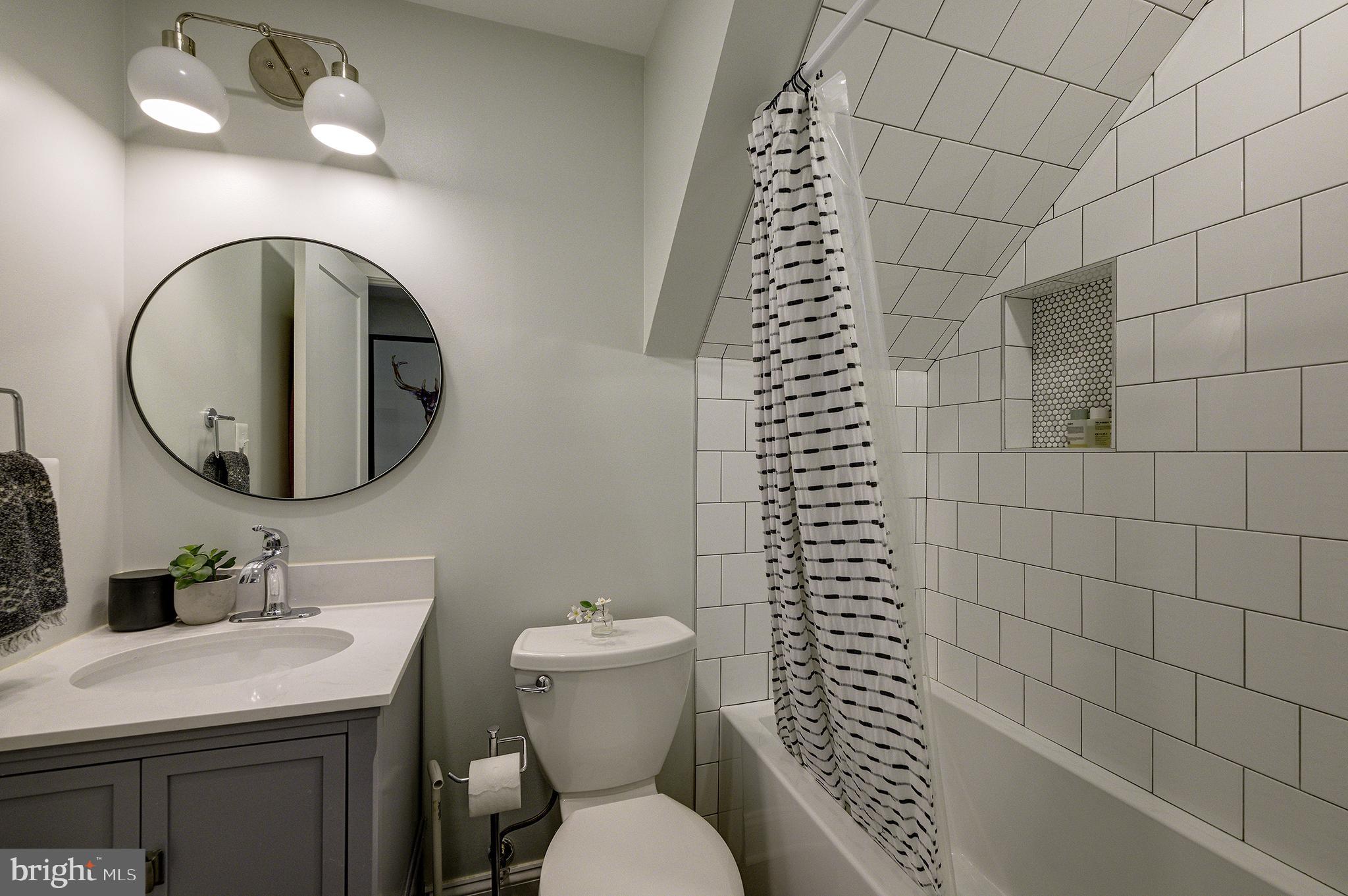5710 Broad Branch Road Northwest Washington, DC 20015 - Photo 19 of 25 a bathroom with a sink a toilet and a mirror