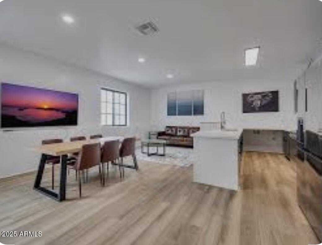 842 South Farmer Avenue Tempe, AZ 85281 - Photo 3 of 14 a living room with furniture a flat screen tv and a wooden floor