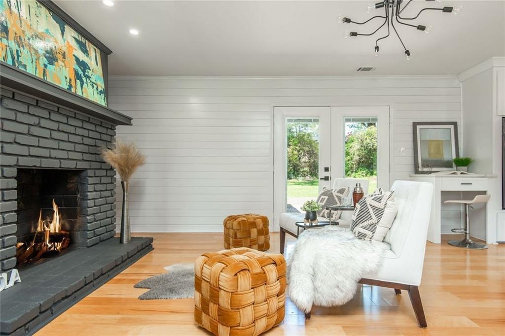3365 Ardley Road Southwest Atlanta, GA 30311 - Photo 14 of 62 a living room with furniture a fireplace and a flat screen tv