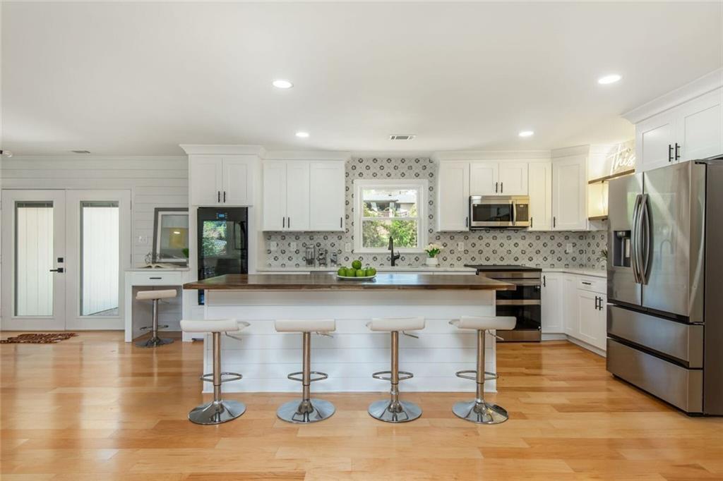 3365 Ardley Road Southwest Atlanta, GA 30311 - Photo 22 of 62 a kitchen with stainless steel appliances granite countertop a refrigerator and a stove top oven