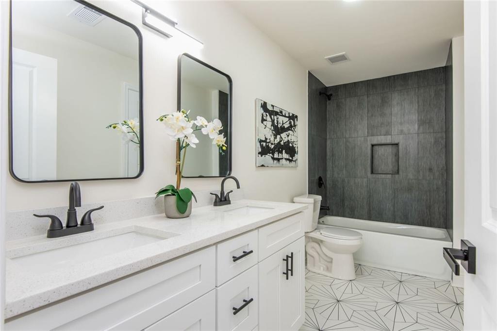 3365 Ardley Road Southwest Atlanta, GA 30311 - Photo 34 of 62 a bathroom with a double vanity sink toilet and shower