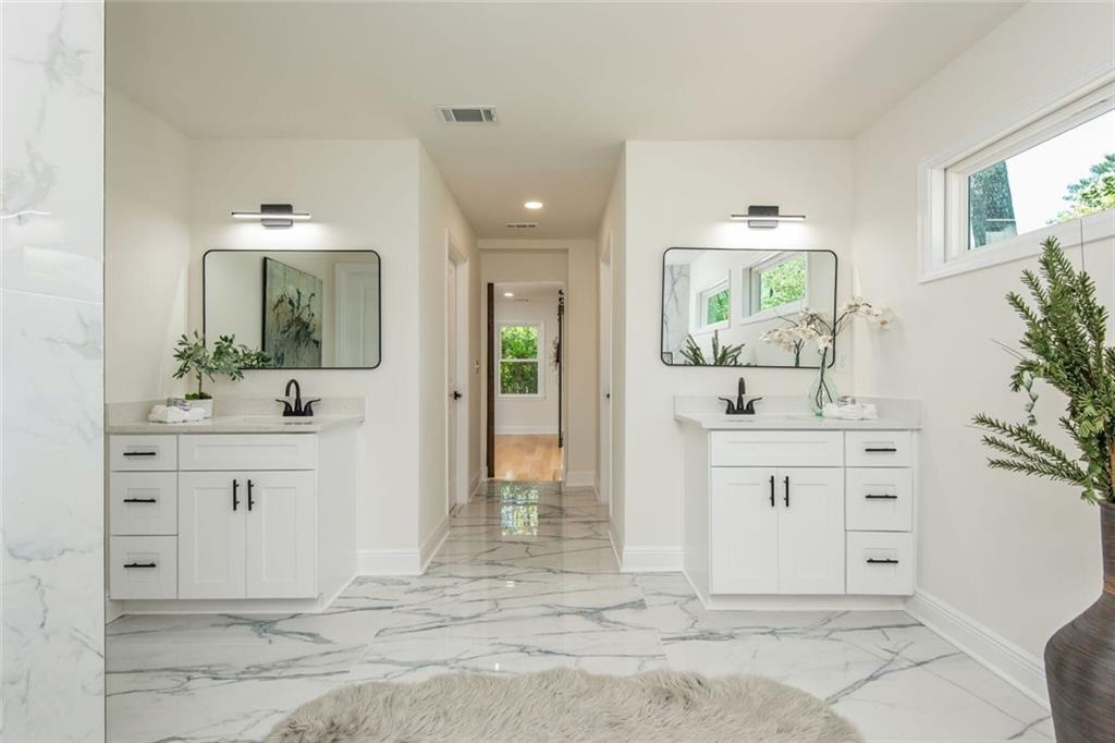 3365 Ardley Road Southwest Atlanta, GA 30311 - Photo 49 of 62 a bathroom with a sink vanity granite tub shower and a mirror