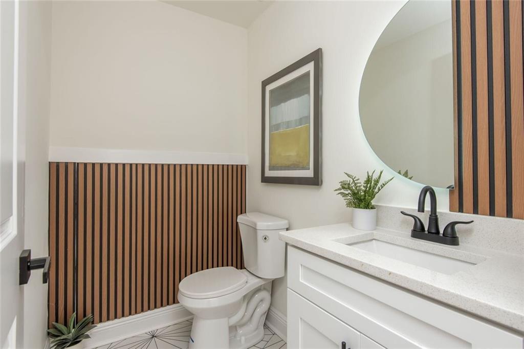 3365 Ardley Road Southwest Atlanta, GA 30311 - Photo 51 of 62 a bathroom with a toilet a sink and mirror