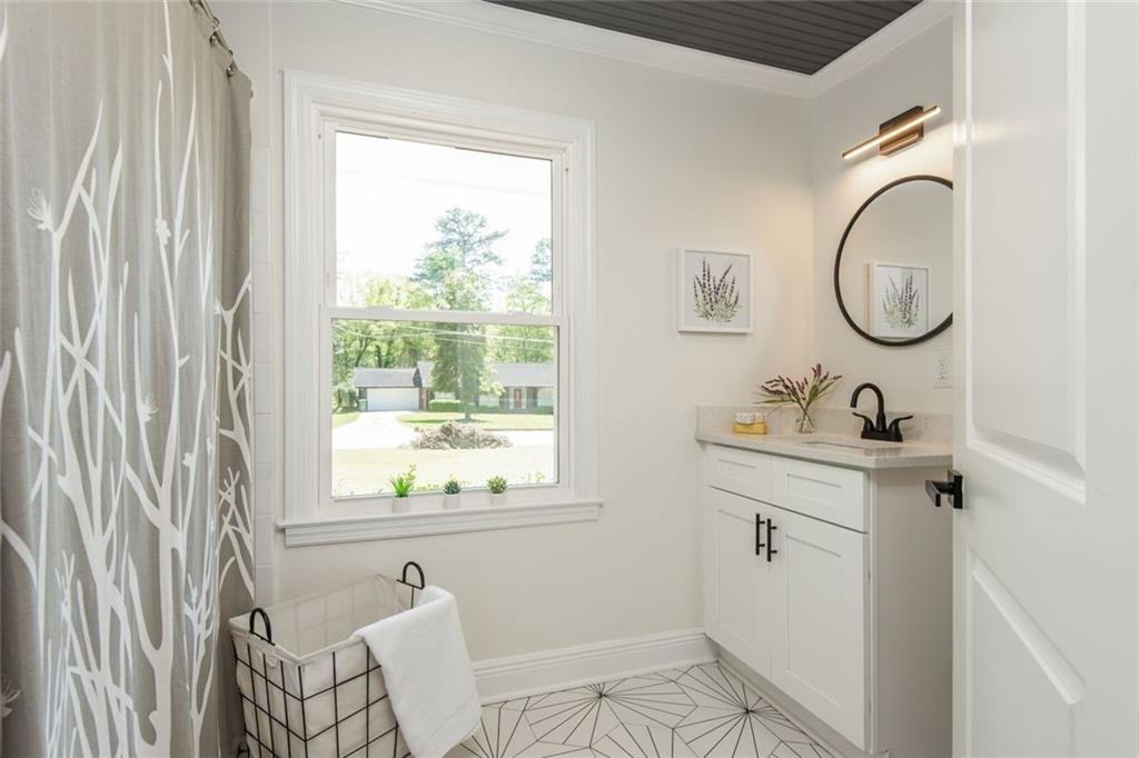 3365 Ardley Road Southwest Atlanta, GA 30311 - Photo 56 of 62 a bathroom with a sink and a mirror