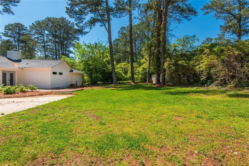 3365 Ardley Road Southwest Atlanta, GA 30311 - Photo 60 of 62 a backyard of a house with lots of green space