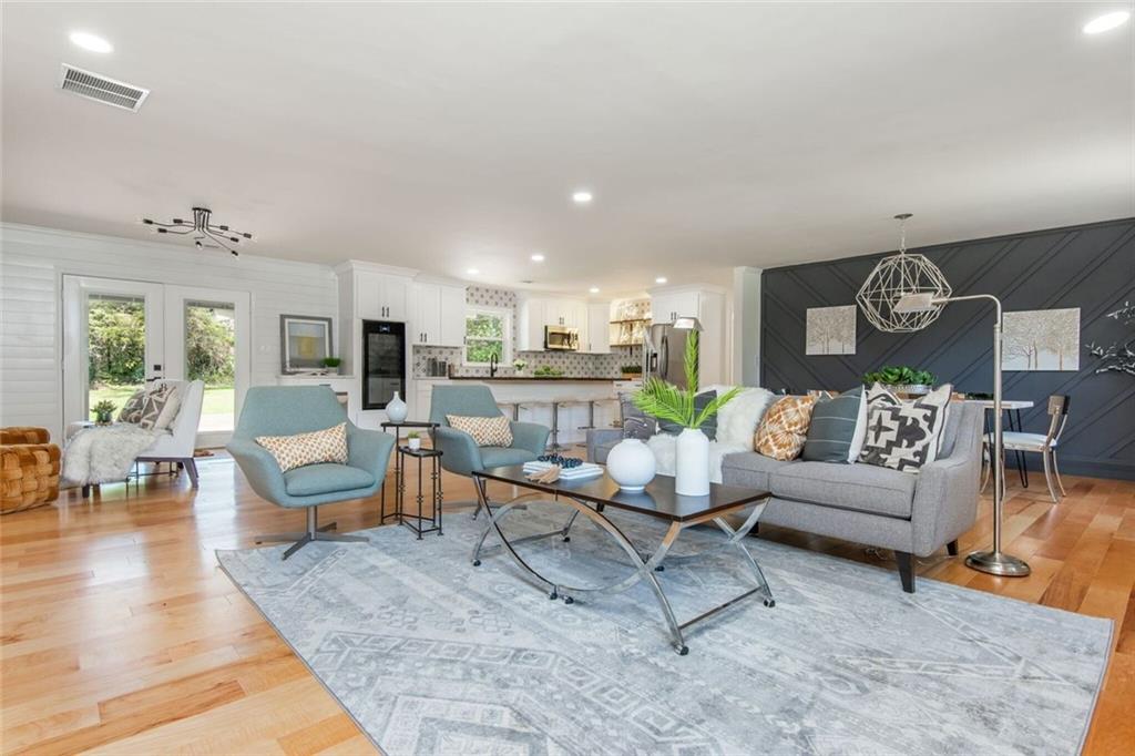 3365 Ardley Road Southwest Atlanta, GA 30311 - Photo 8 of 62 a living room with furniture kitchen view and a wooden floor