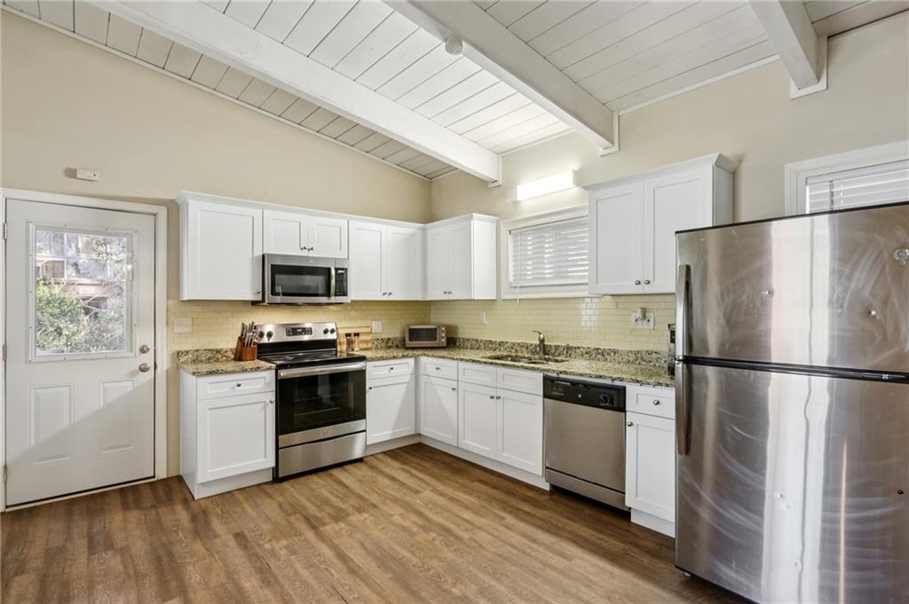 1291 Richard Road Decatur, GA 30032 - Photo 5 of 16 a kitchen with cabinets stainless steel appliances a sink and a refrigerator