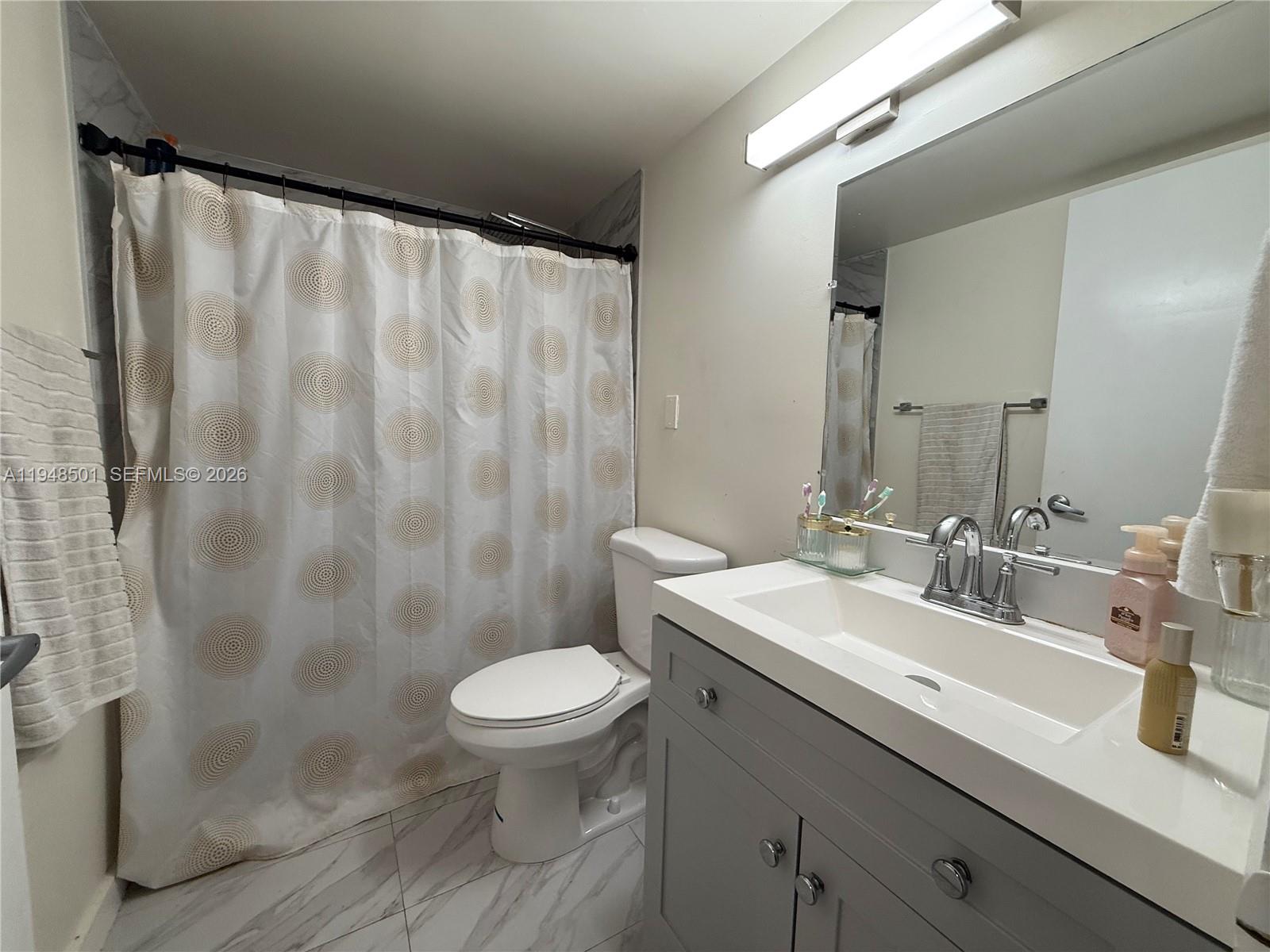 11800 Southwest 18th Street, Unit 4104 Miami, FL 33175 - Photo 5 of 10 a bathroom with a sink and a mirror