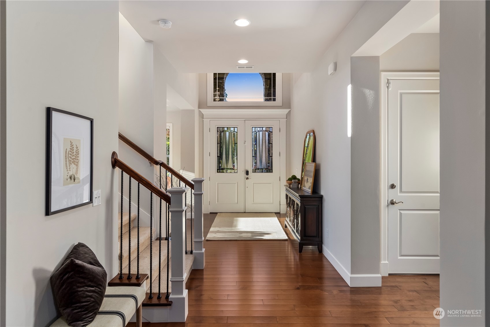 5619 Northeast 2nd Court Renton, WA 98059 - Photo 5 of 40 a view of a hallway with entryway wooden floor and front door