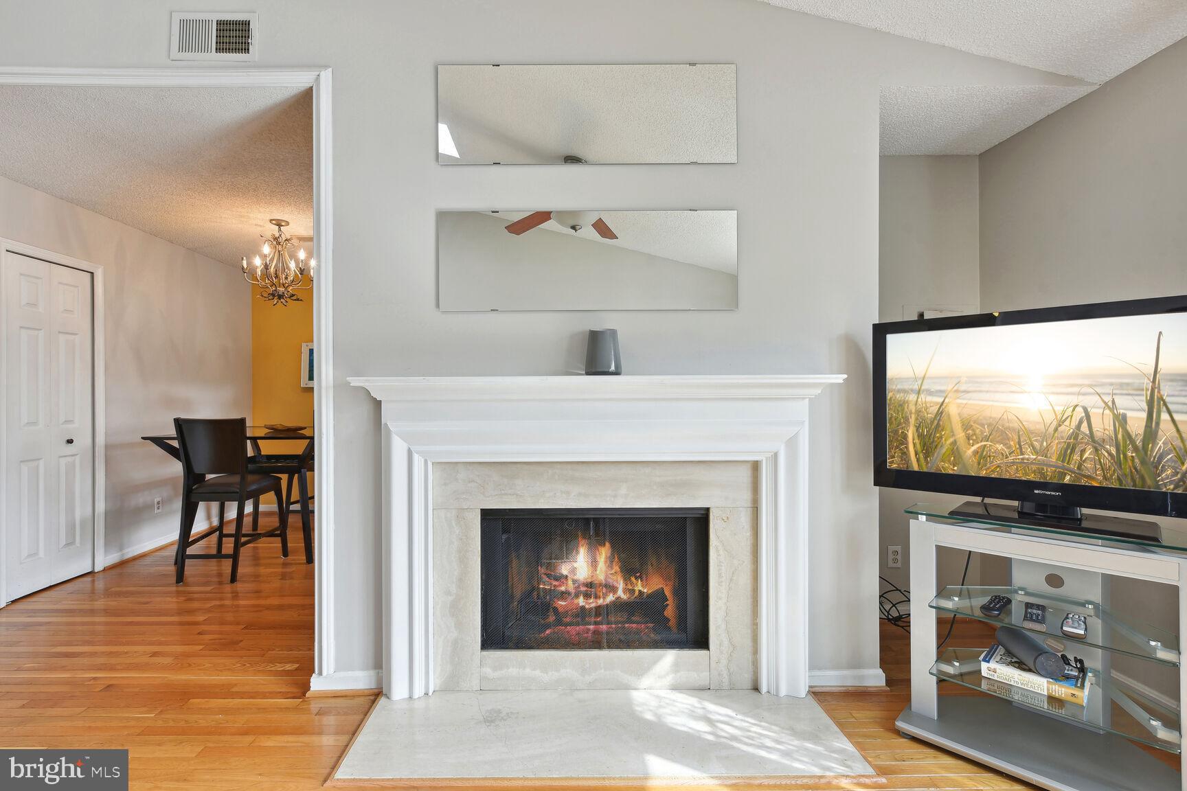 a living room with fireplace and a flat screen tv