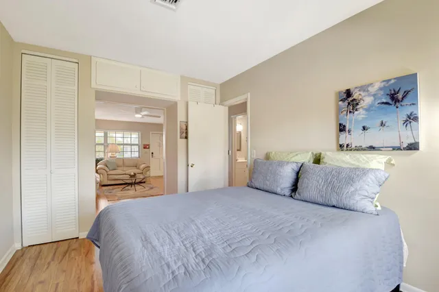 a bedroom with a large bed and a chandelier