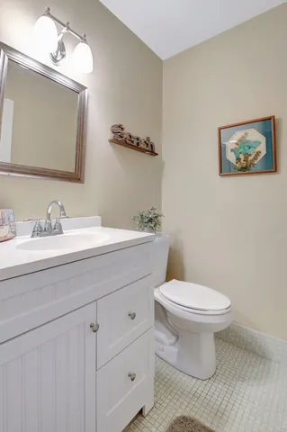 a bathroom with a toilet a sink and mirror