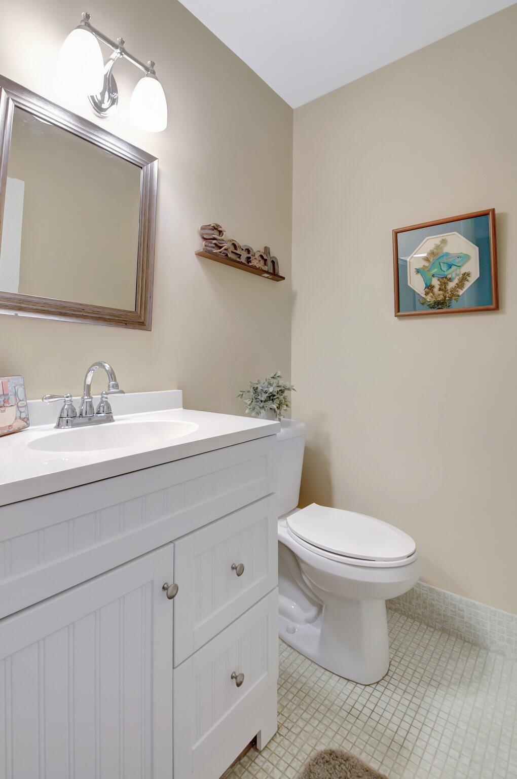 5505 North Ocean Boulevard, Unit 8202 Ocean Ridge, FL 33435 - Photo 16 of 26 a bathroom with a toilet a sink and mirror