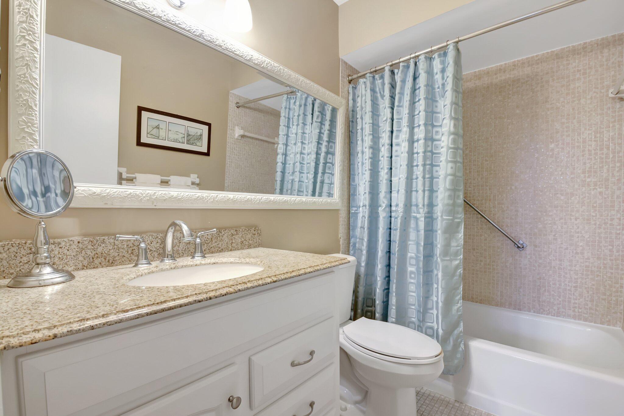 5505 North Ocean Boulevard, Unit 8202 Ocean Ridge, FL 33435 - Photo 20 of 26 a bathroom with a granite countertop sink toilet and shower