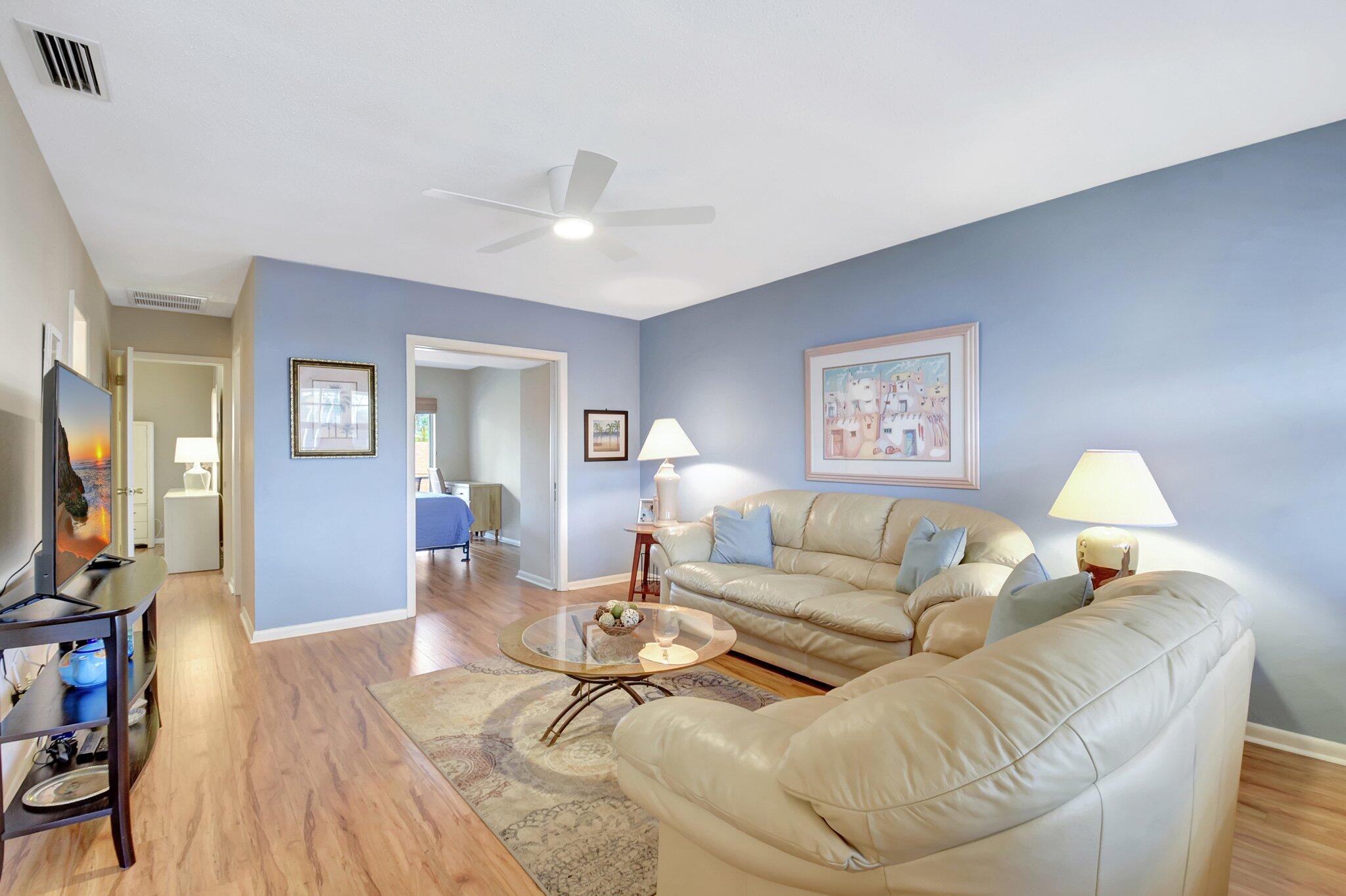 5505 North Ocean Boulevard, Unit 8202 Ocean Ridge, FL 33435 - Photo 5 of 26 a living room with furniture a flat screen tv and a table