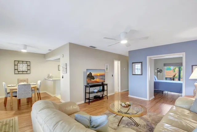 a living room with furniture and wooden floor