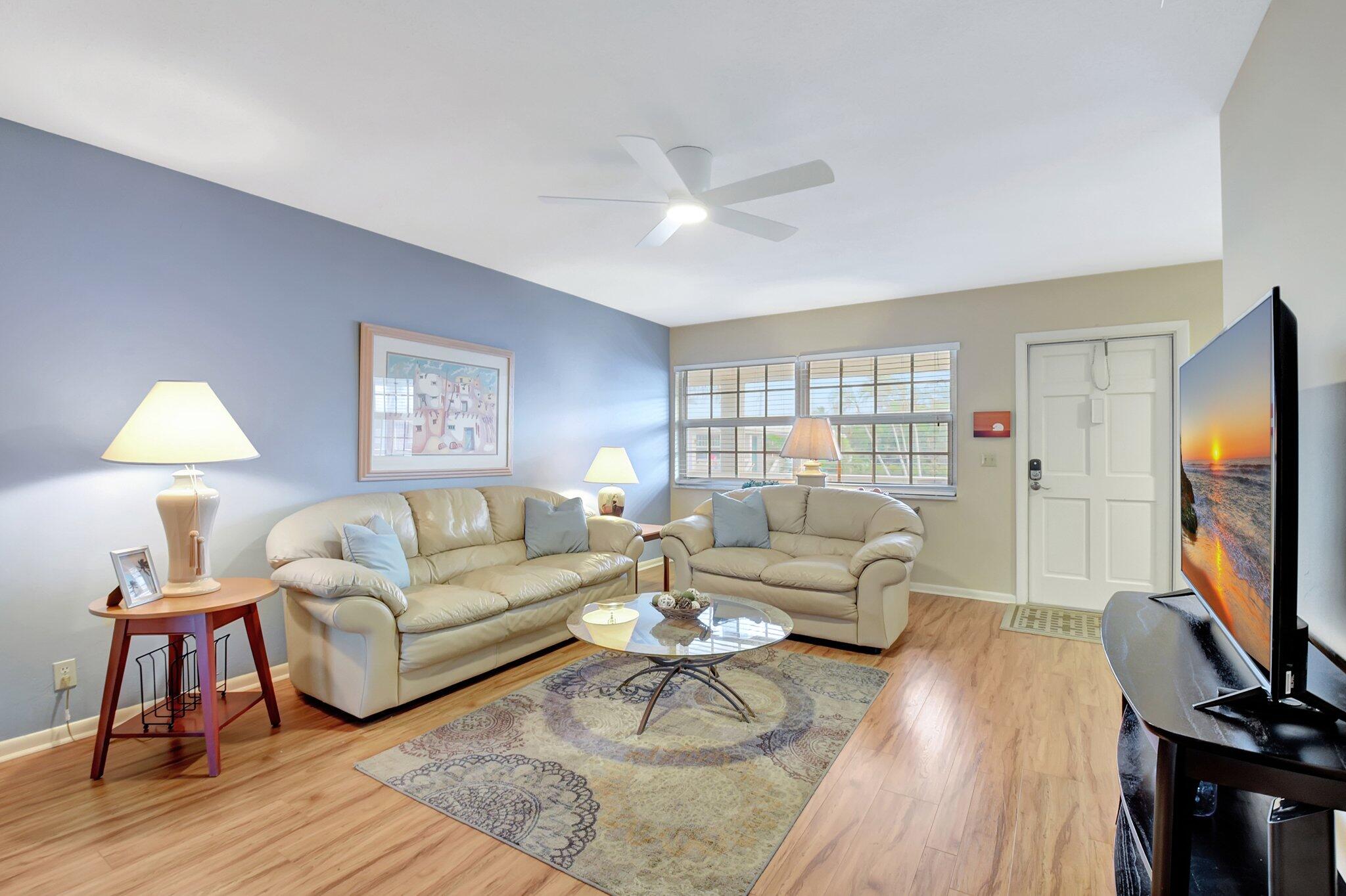 5505 North Ocean Boulevard, Unit 8202 Ocean Ridge, FL 33435 - Photo 7 of 26 a living room with furniture and a flat screen tv