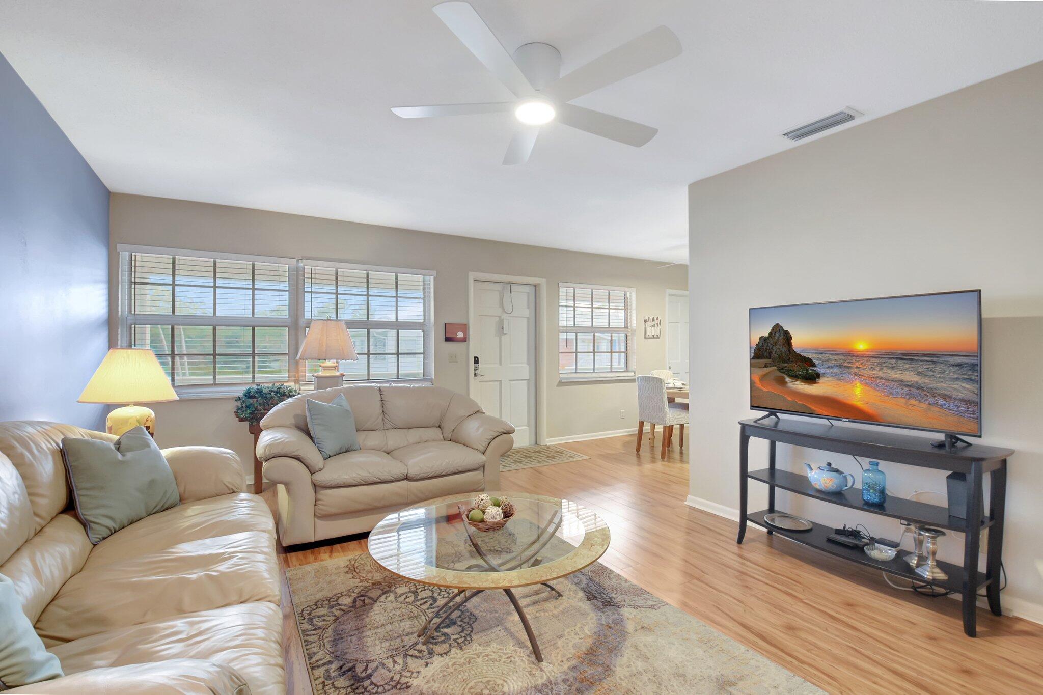 5505 North Ocean Boulevard, Unit 8202 Ocean Ridge, FL 33435 - Photo 8 of 26 a living room with furniture and a flat screen tv