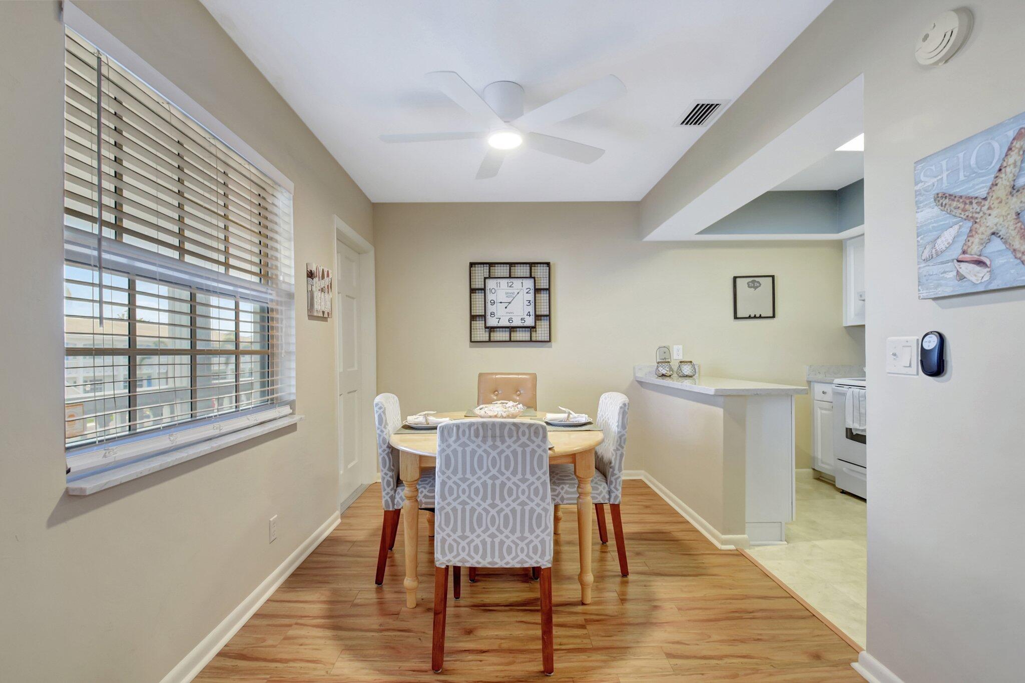5505 North Ocean Boulevard, Unit 8202 Ocean Ridge, FL 33435 - Photo 9 of 26 a view of a dining room with furniture window and wooden floor