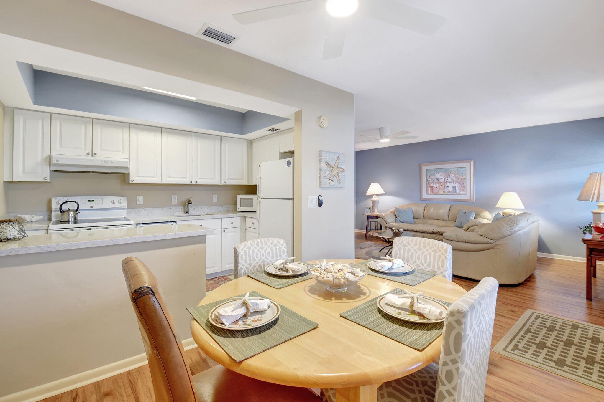 5505 North Ocean Boulevard, Unit 8202 Ocean Ridge, FL 33435 - Photo 10 of 26 a dining room with wooden floor and kitchen view