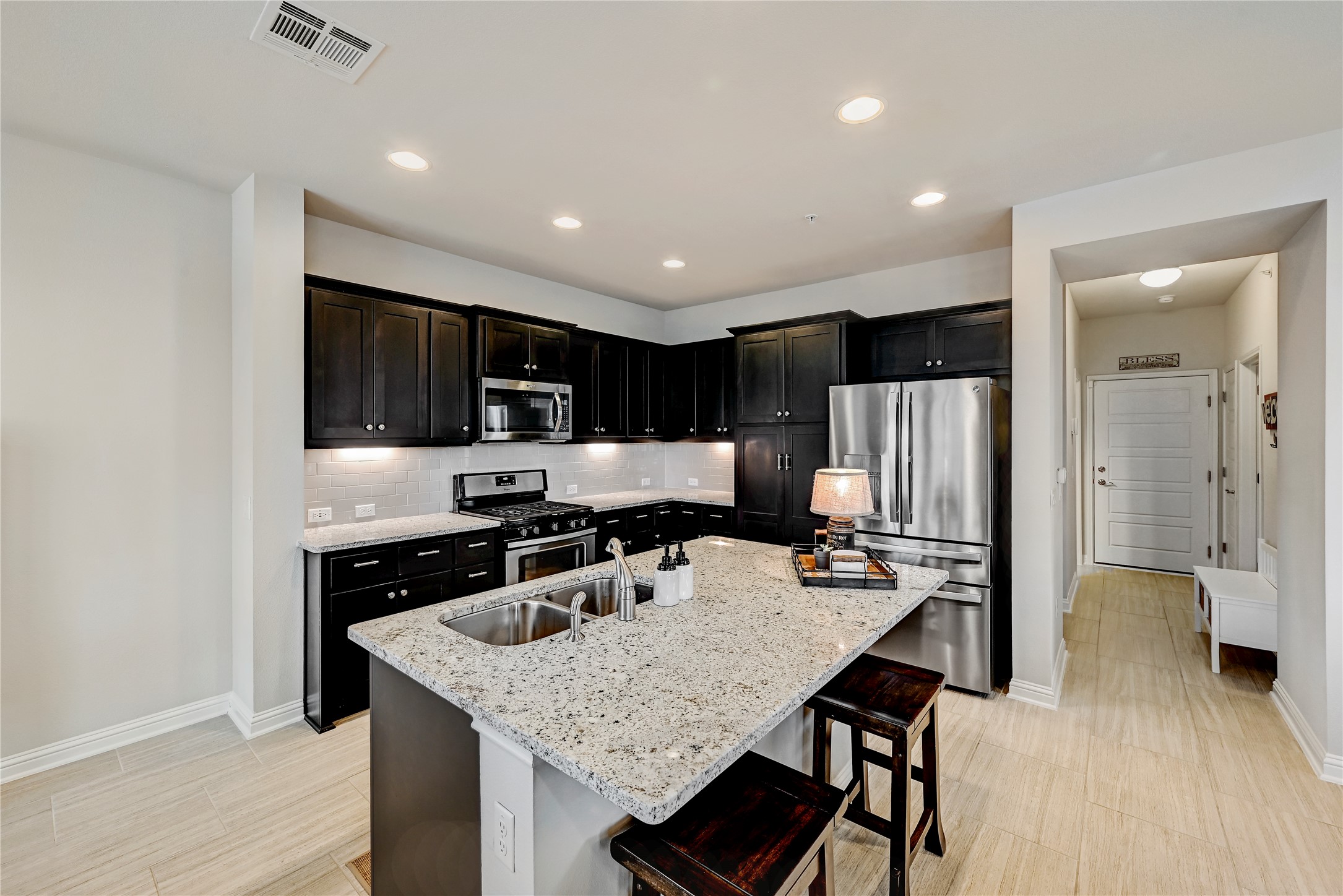 6814 East Riverside Drive, Unit 64 Austin, TX 78741 - Photo 7 of 17 A gourmet kitchen offers granite counters, stainless steel appliances, and sleek dark cabinetry.