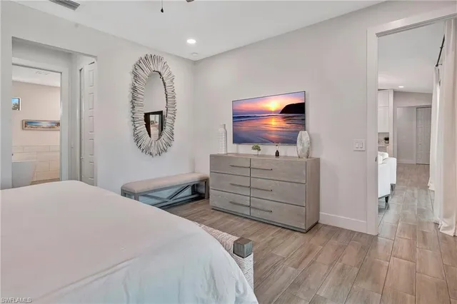 a bedroom with a bed and a flat screen tv