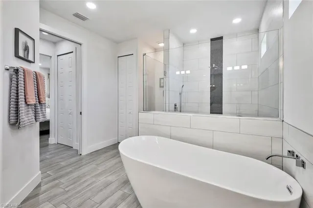 a bathroom with a bathtub and a shower