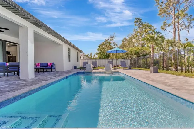 a view of yard with swimming pool and sitting area