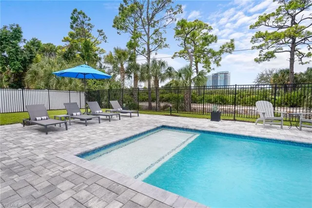 a view of a swimming pool with a patio and a garden