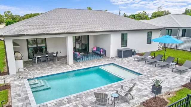 a view of a house with backyard porch and furniture