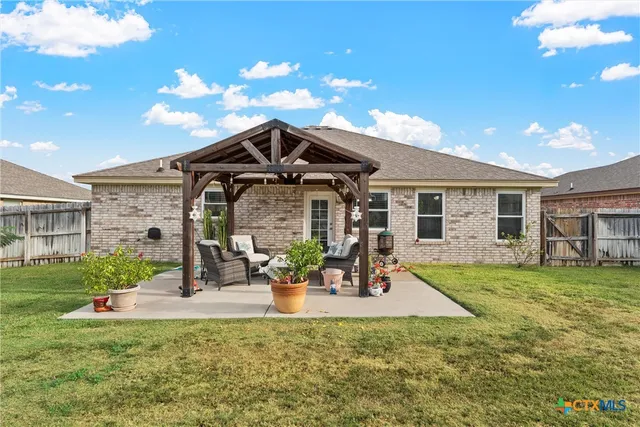 a front view of a house with a garden and patio