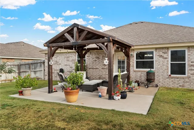 a view of a house with backyard porch and sitting area