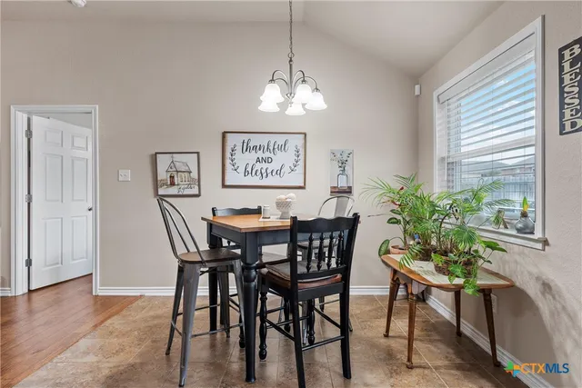 a view of a dining room with furniture and window
