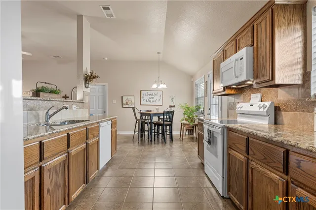 a kitchen with lots of counter top space and dining table