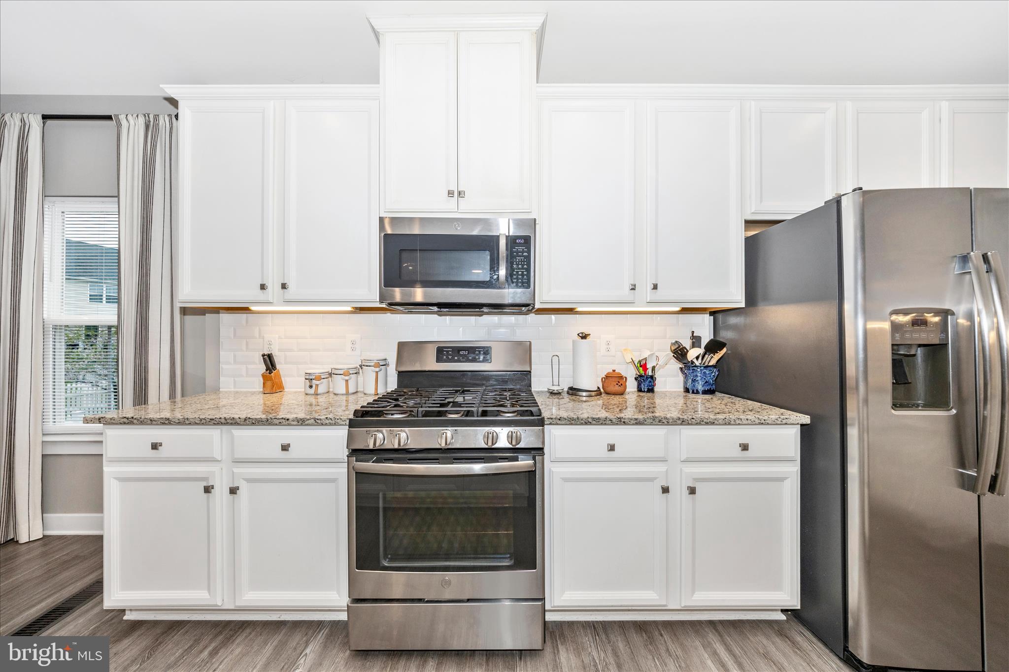1202 Dargon Quarry Lane Brunswick, MD 21716 - Photo 15 of 76 a kitchen with white cabinets and stainless steel appliances