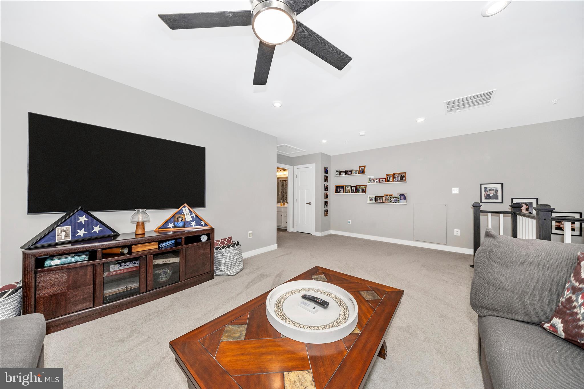 1202 Dargon Quarry Lane Brunswick, MD 21716 - Photo 27 of 76 a living room with furniture and a flat screen tv