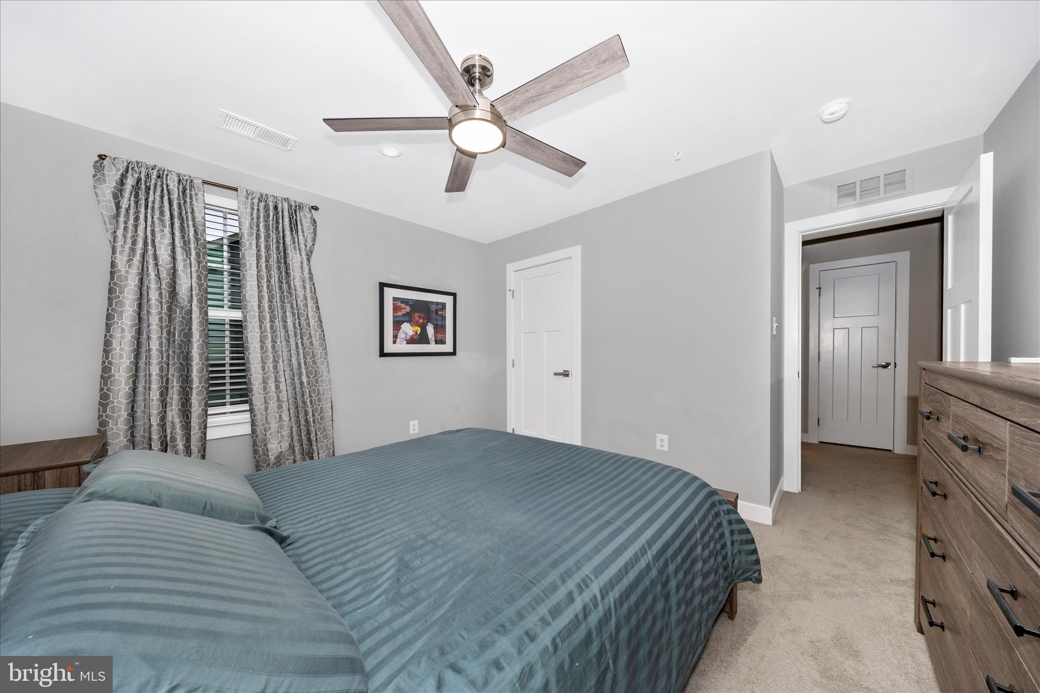 1202 Dargon Quarry Lane Brunswick, MD 21716 - Photo 33 of 76 a bedroom with a large bed and a chandelier